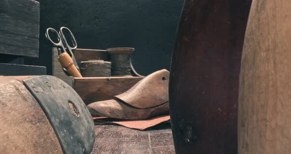 Antique shoemaker workshop. Cobbler workshop with tools, strap, leather.