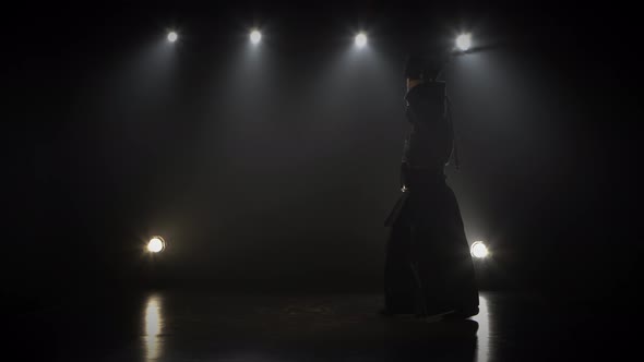 Masculine Kendo Fighter Practicing Martial Art with the Shinai Sword.