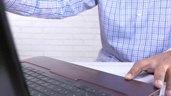 Young Man Opening a Laptop and Start Working