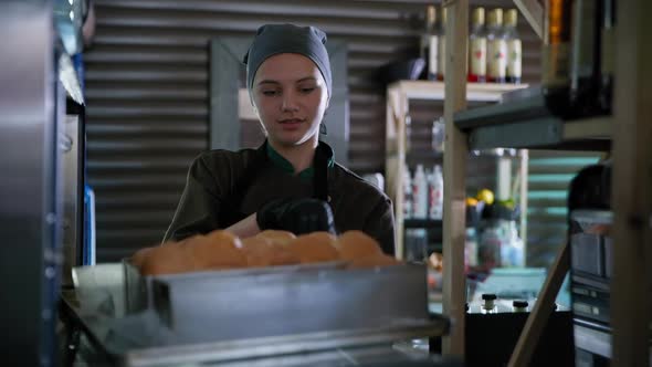 Bakery, Professional Female Chef Working with Dough, Takes Out Smoke From Hot Oven with Smoke with