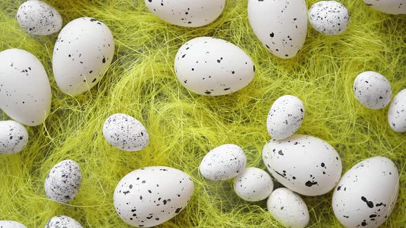 White Easter Eggs with Freckles Placed on the Yellow Hay