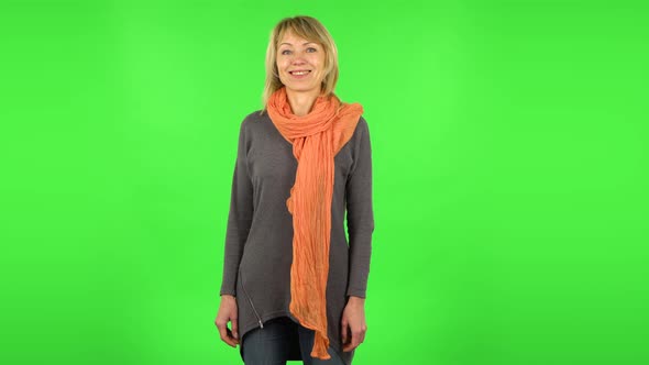 Middle Aged Blonde Woman Is Smiling While Looking at Camera