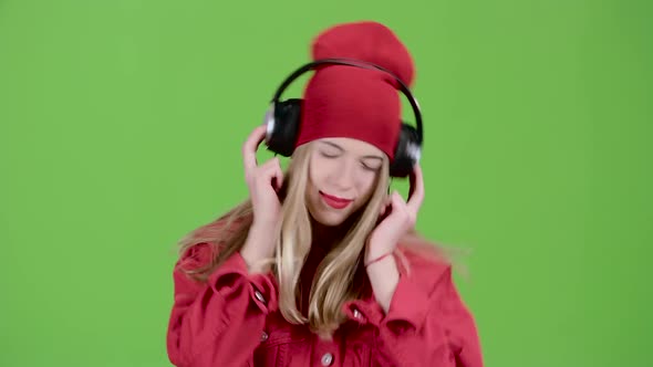 Teenager Listens To Music on Headphones. Green Screen