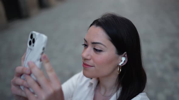 Handsome brunette woman in headphones making photo