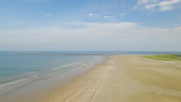 Wide angle aerial view of beach moving along shoreline