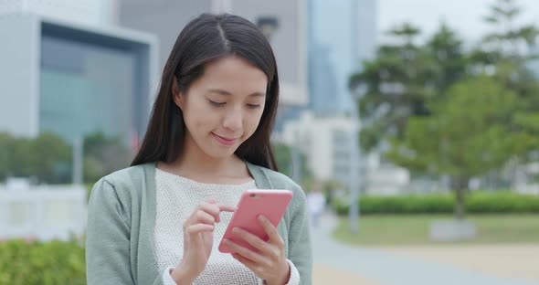 Woman use of mobile phone in city