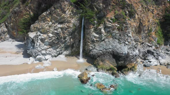 Amazing Aerial of the Wild Nature with Waterfall Falling Into the Blue Ocean