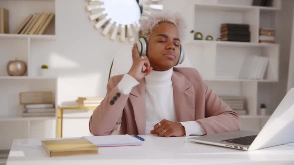 Young African American Business Woman Listening to Music in Headphones