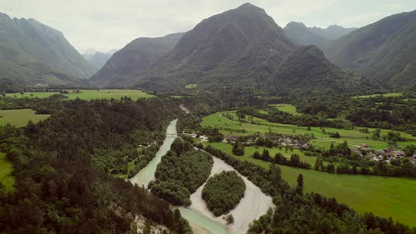 Aerial view of a small village with typical houses next to Soca river, Slovenia.