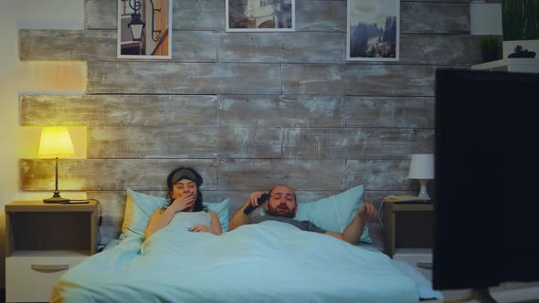 Tired Couple in Their Bedroom Going To Sleep