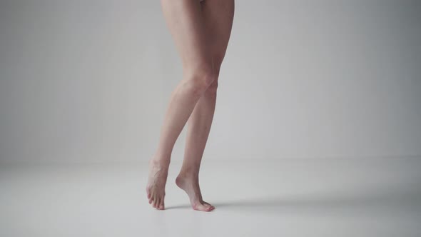 Girl Standing on Tiptoes Barefoot. Female Legs Close Up