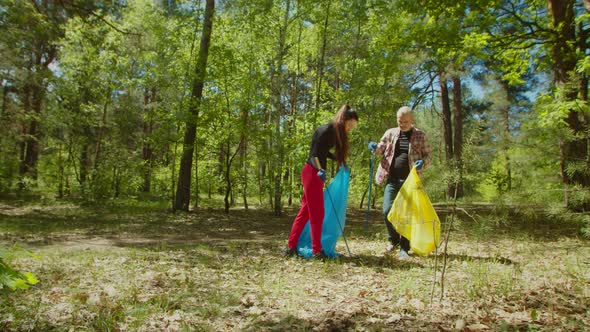 Ecology Friendly People with Garden Collecting Garbage and Plastic Waste in Forest