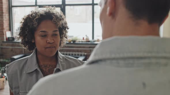 Young Woman Talking to Male Colleague