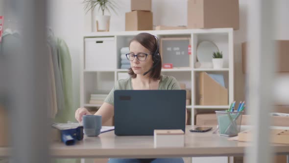 Middle-aged Woman Working in Internet Apparel Shop