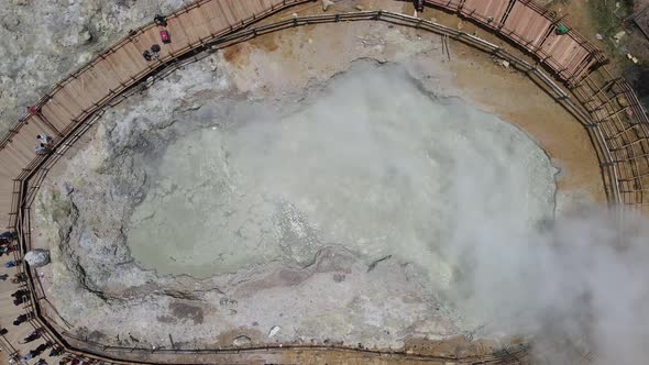 Aerial view of crater with the background of sulfur vapor coming out of the sulfur marsh.