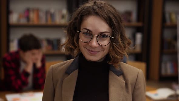 Portrait of an Attractive Short Haired European Girl Student in Glasses Standing in High School