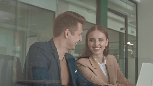 Two Business Colleagues Working Together on Laptop