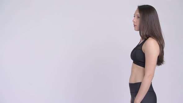 Profile View of Young Happy Multi-ethnic Woman with Arms Crossed Ready for Gym