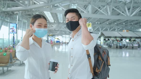 two attractive asian businessman and businesswoman wear face mask protection