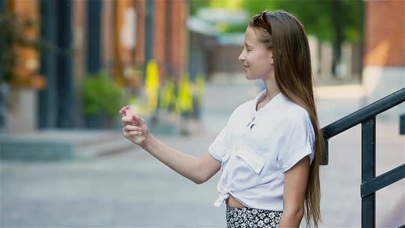 Cute Girl Gets Her Face Refreshed in Hot Day