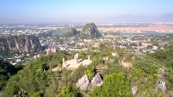 Upper View Couple Take Photos on Ground at Mountain Top