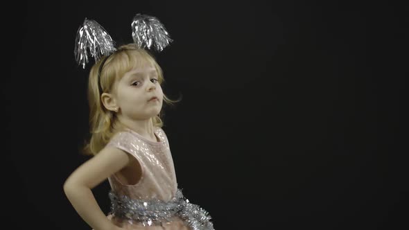 Happy Beautiful Little Baby Girl in Glossy Dress. Christmas. Make Faces, Dance