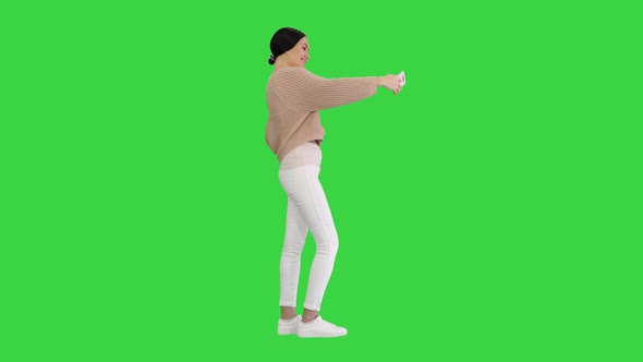 Pretty Brunette Taking a Selfie on a Green Screen Chroma Key