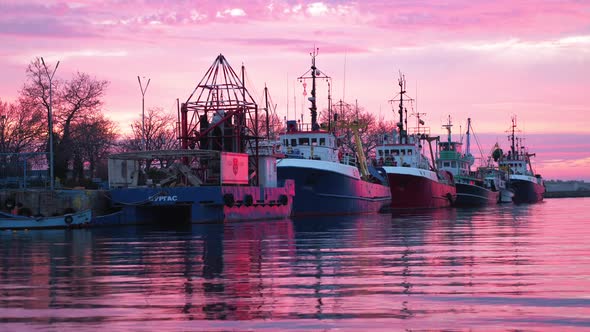 Cargo Ships Moored On The Port With Beautiful Pink Sunset Over The Calm Sea In Bulgaria. - static sh