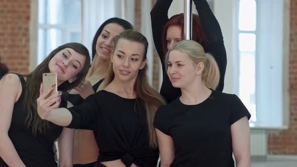 Group of Beautiful Young Women Taking a Selfie During a Break on a Pole Fitness Class