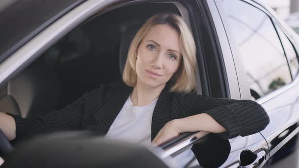 Portrait of an Elegant Business Lady in a New Car Dealership