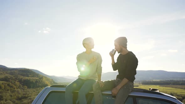 Dolly Shot of Beautiful Couple Relaxing in the Mountain with Cup of Tea.