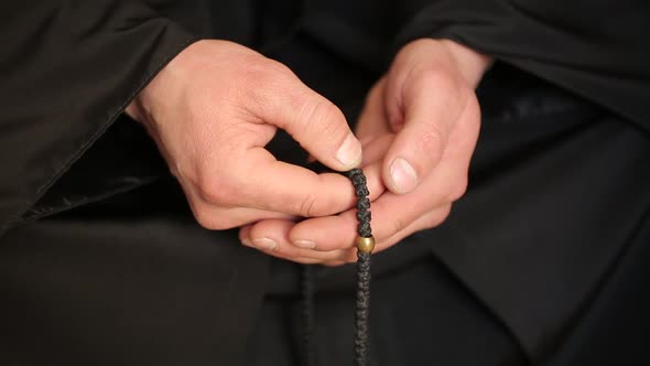 Man Praying With Rosary