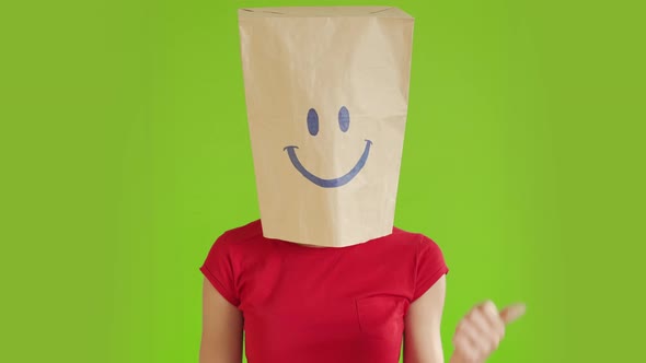 A Crazy Woman is Gesturing with a Cardboard Box on His Head with Smiley Face Showing a Class with a