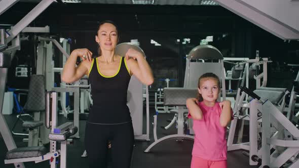 Mother and Daughter in the Gym Family Performs Physical Doing Exercises Fitness Healthy Lifestyle