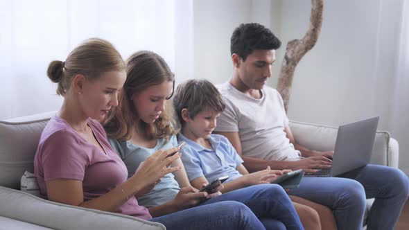 Family Sitting Together Using Electronic Device