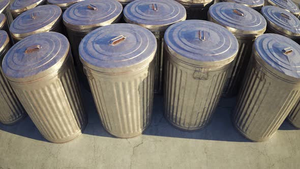 Steel trash bins stacked together in an endless loop lit by the sunlight. 4KHD