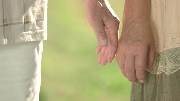 Seniors Gently Touching Hands Together.