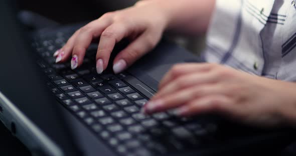 Female Executive Working On Laptop At Workplace