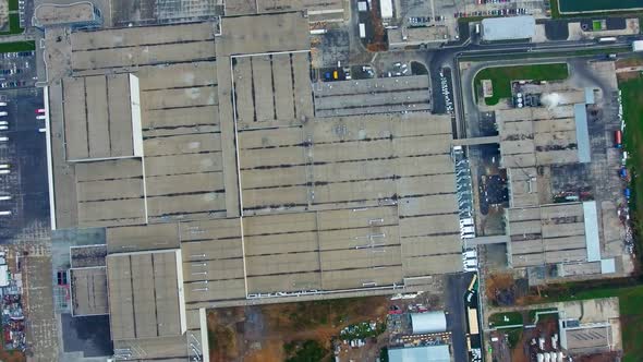 Industrial plant outdoors. Large factory on field. Roofs of buildings of modern industrial plant. 