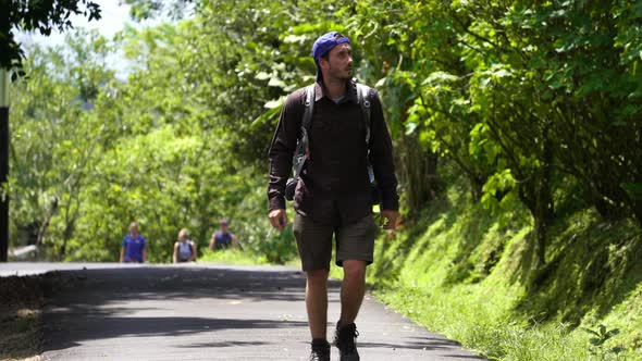 Casual backpacker waling along Costa Rica green deep natural vegetation of Central America, solo tra