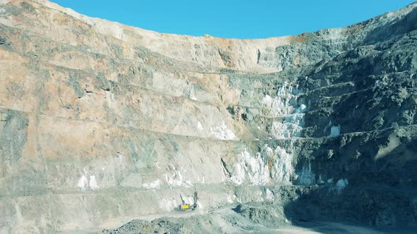 Deep Opencast Mine with a Drilling Machine Working in It