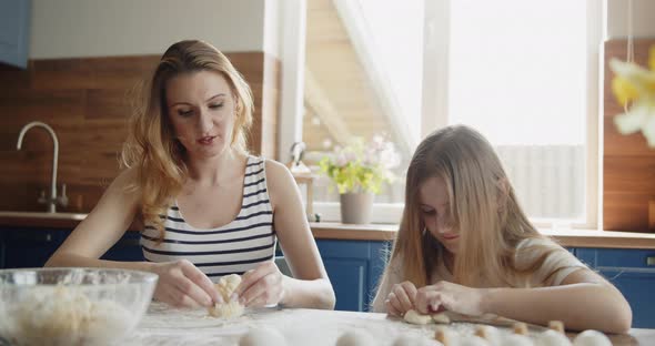 Mother and Daughter Baking Cooking Together in the Kitchen at Home