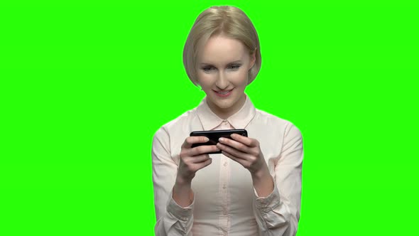 Attractive Businesswoman Plays Video Games on Her Phone