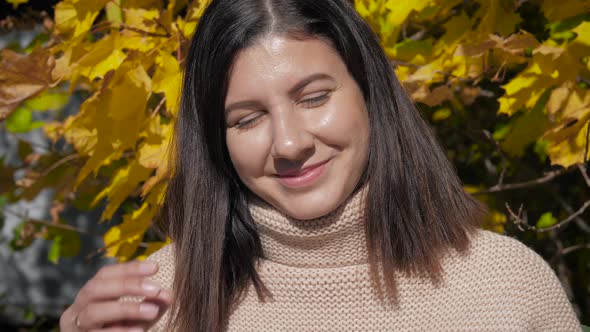 Portrait Of Caucasian Brunette With Brown Eyes Against Of An Autumn Forest