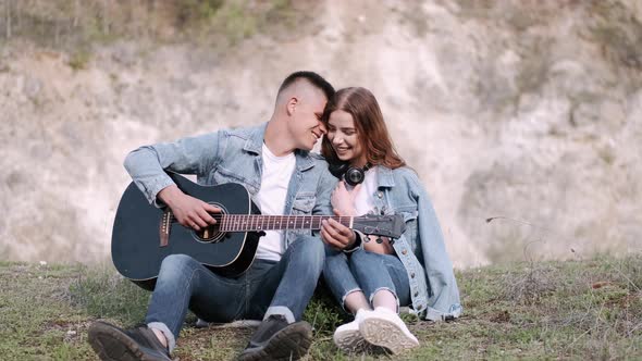 Man Plays Song for Girlfriend on Romantic Date in Forest