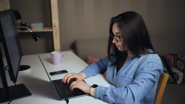 Serious Brunette Woman Using Laptop at Home