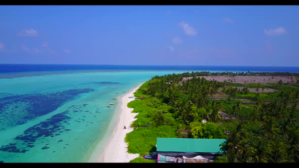 Aerial drone shot panorama of tropical lagoon beach journey by clear ocean with white sand backgroun