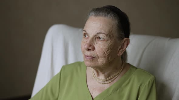 Portrait of Grandmother Sitting on Armchair