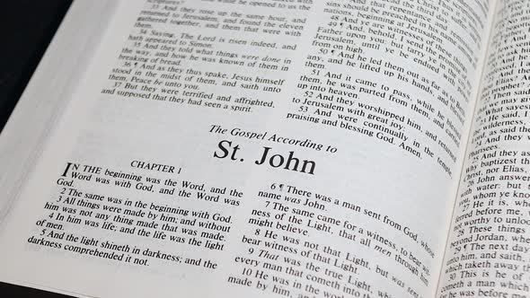 Close Up Shot of  Bible Page Turning to the book of John
