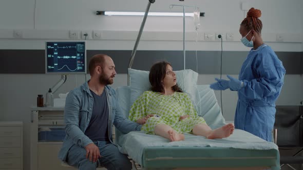 Pregnant Patient Laying in Hospital Ward with Medical Equipment